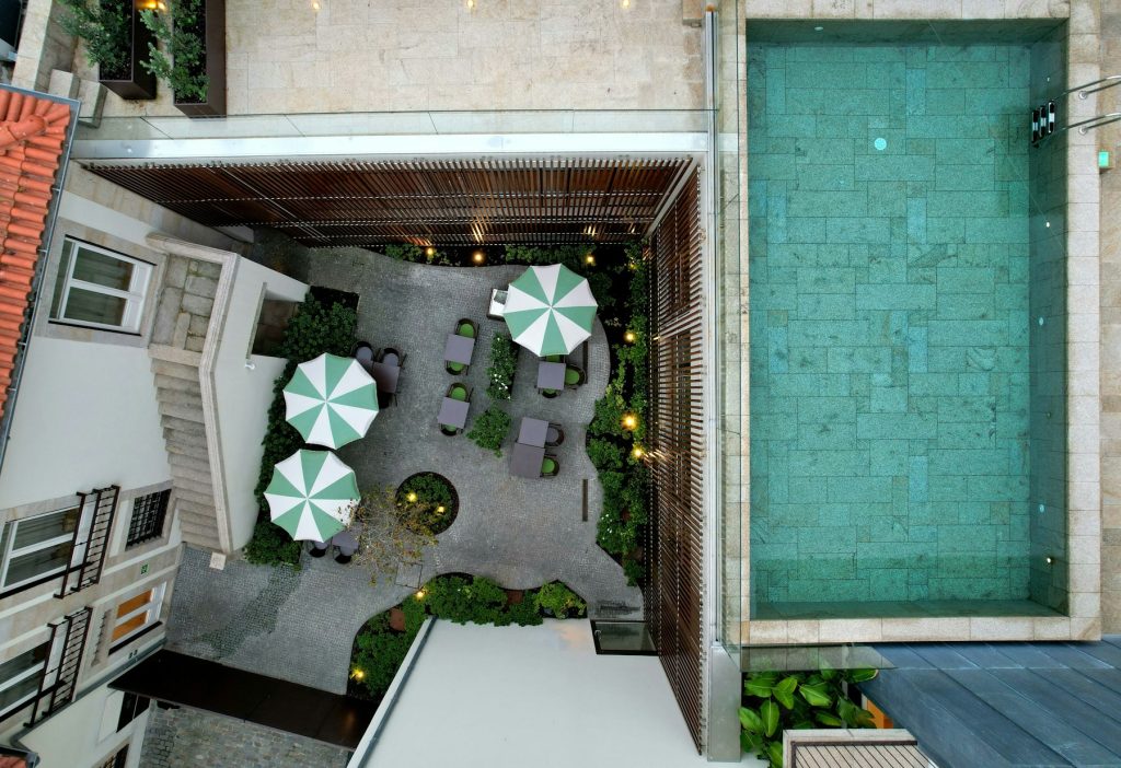Boutique hotel for sale: aerial view of a small hotel courtyard and pool