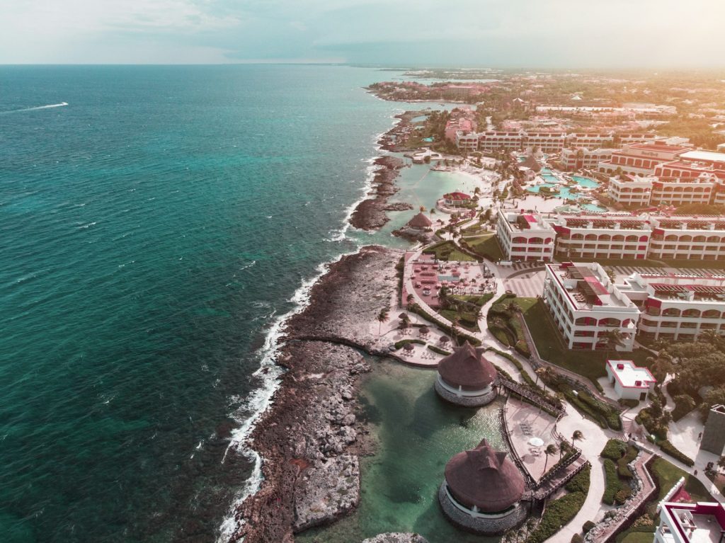 Aerial view of beachfront hotels in the Riviera Maya, where IVA Mexico rules shape hotel acquisition costs