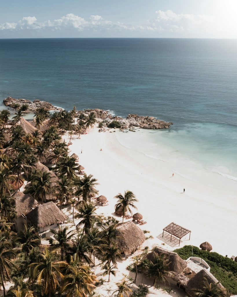 Mexico property taxes: aerial view of a palm-lined beach on Mexico’s Riviera Maya coast