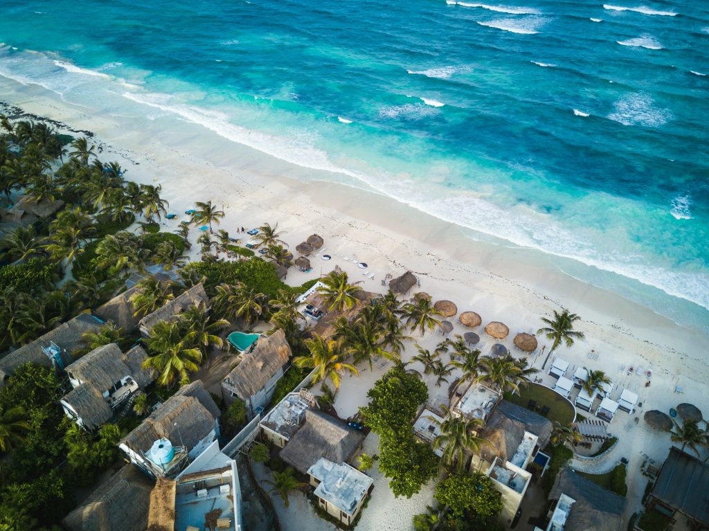 Hotel financing: aerial view of small beachfront hotels along a Caribbean shoreline