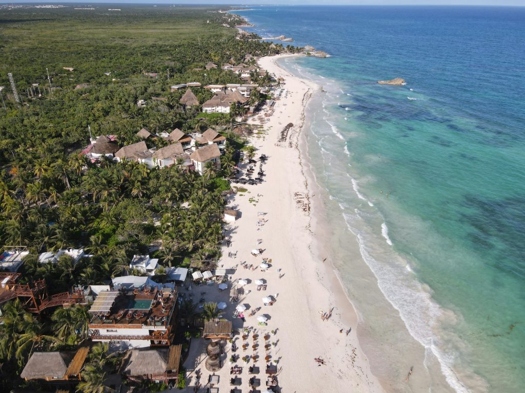 Small resorts for sale: aerial view of boutique beach hotels along a Caribbean coastline